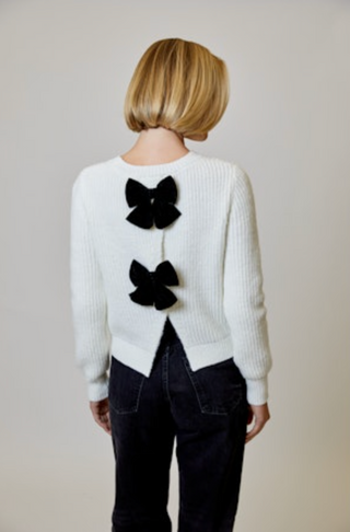 White ribbed sweater with black bows detail in back