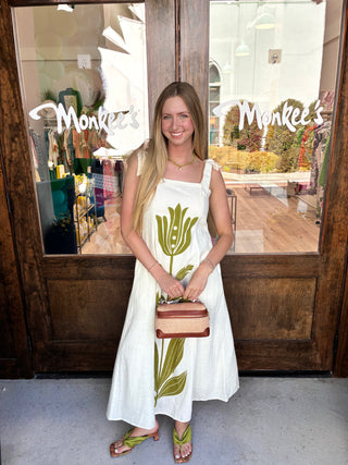 Cream long maxi dress with green floral design and tie straps