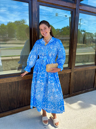 Blue and white floral maxi dress with puff sleeves and a belted waistline.