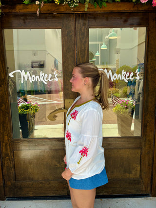 White blouse with green and pink embroidery
