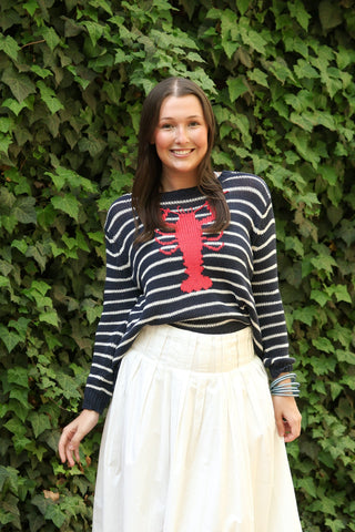 Navy and white striped sweater with a lobster on it.