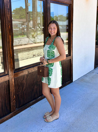 Cream mini dress with green florals throughout.