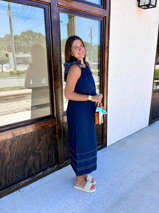 Navy maxi dress with a high neckline and bow tied straps