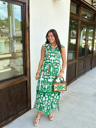 White and green patterned maxi dress with orange trim and a dramatic collar 